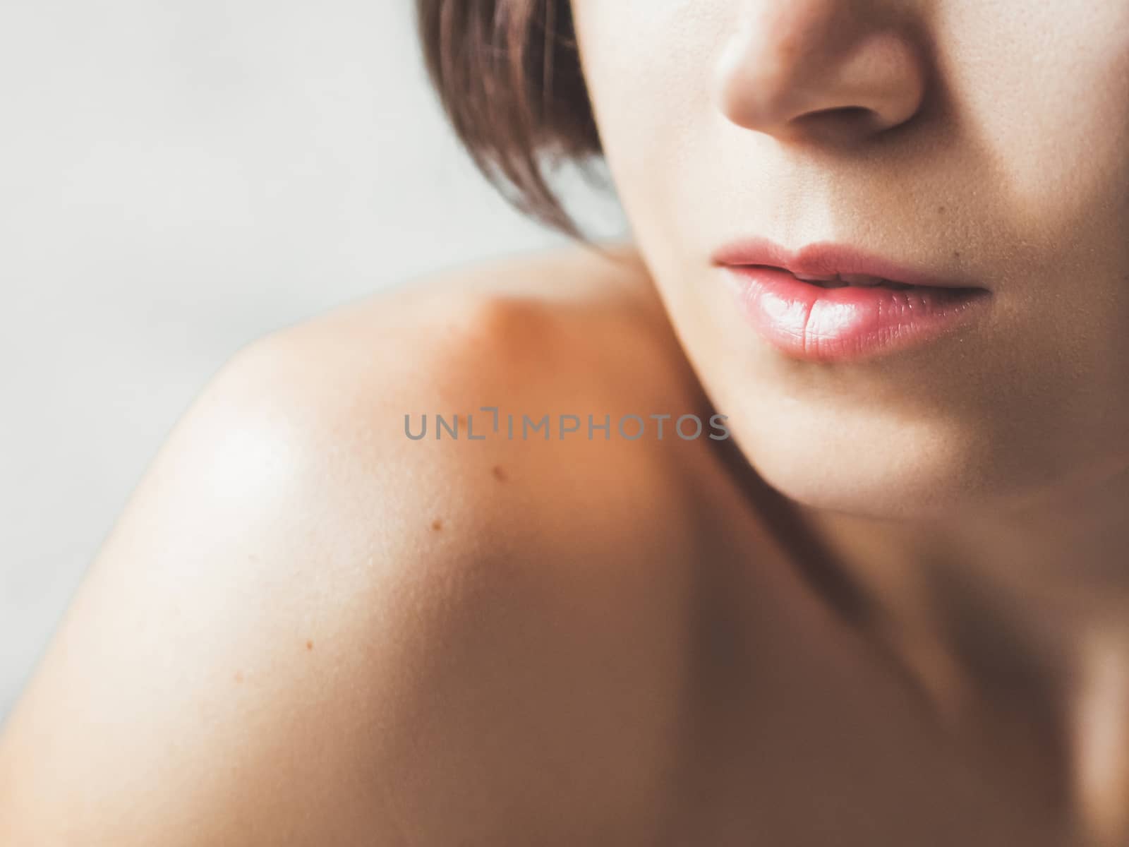 Close up portrait of woman on white background. Natural beauty without make up.