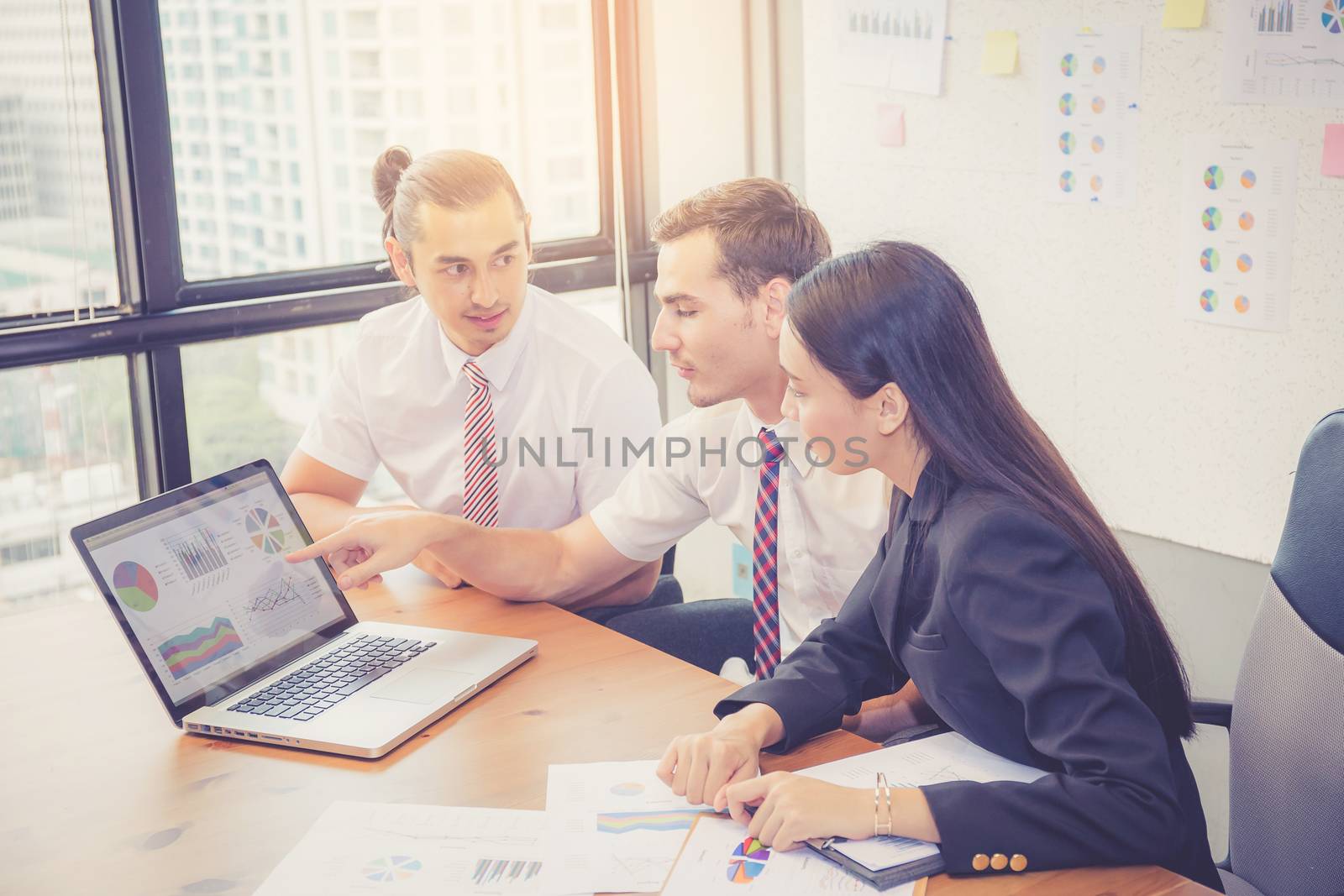 Business team having a meeting using laptop during a meeting and presents profit, Present report analysis and planning with brainstorm in teamwork.