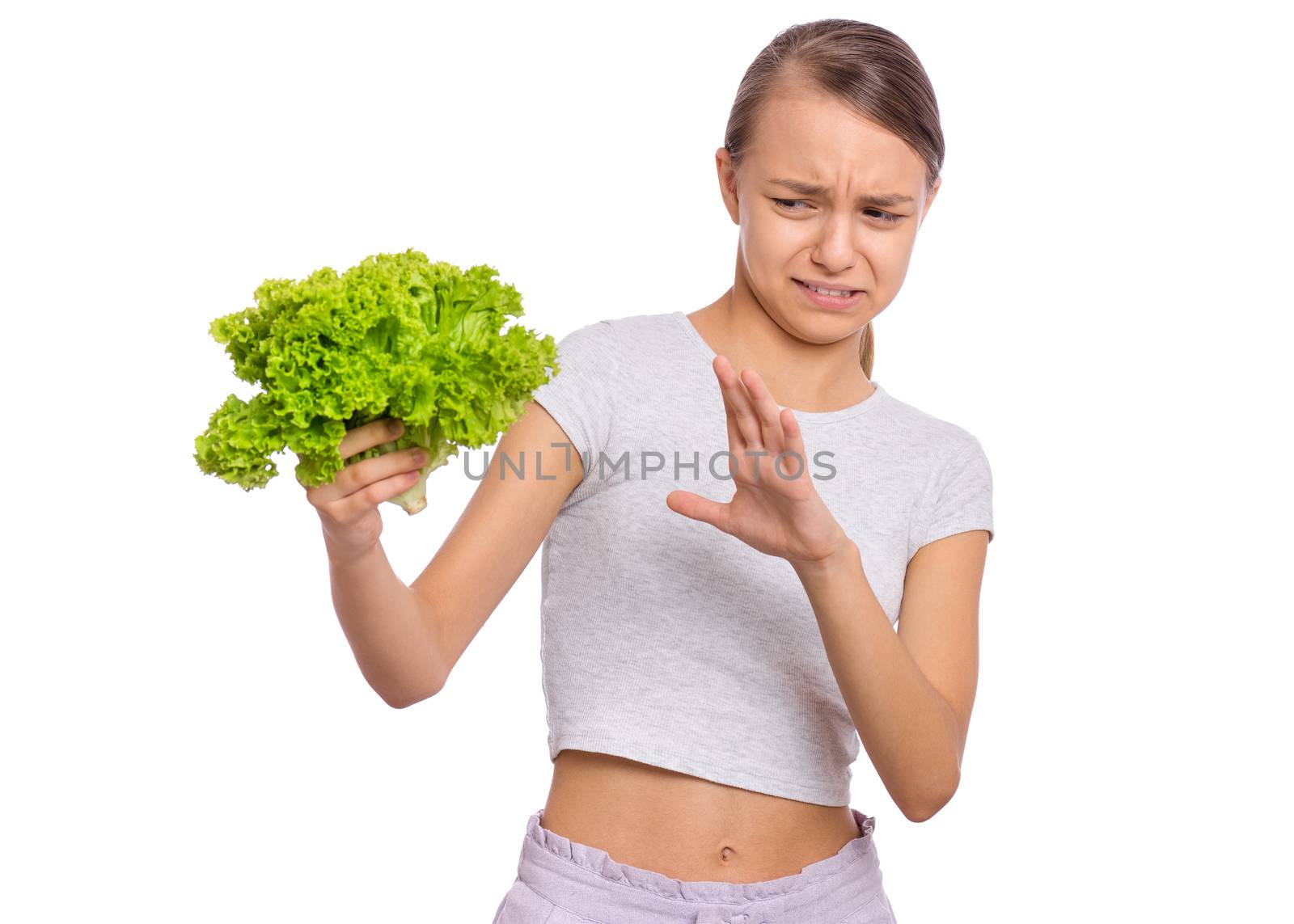 Beautiful young teen girl holding holding green salad, isolated on white background