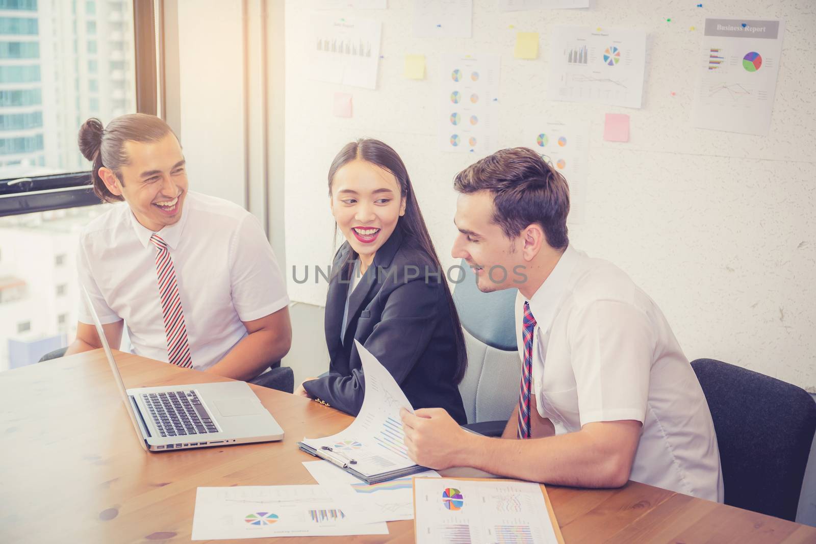 Business team having a meeting using laptop during a meeting and by nnudoo