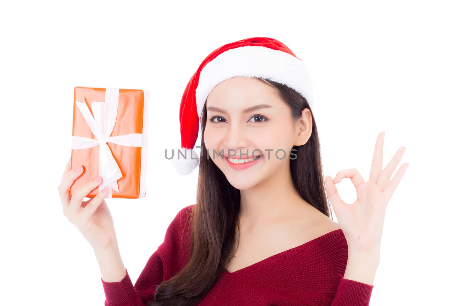 Happy asian woman with smile holding gift box of xmas, Present girl with celebration christmas, girl gesture ok isolated on white background, shopping with season concept.