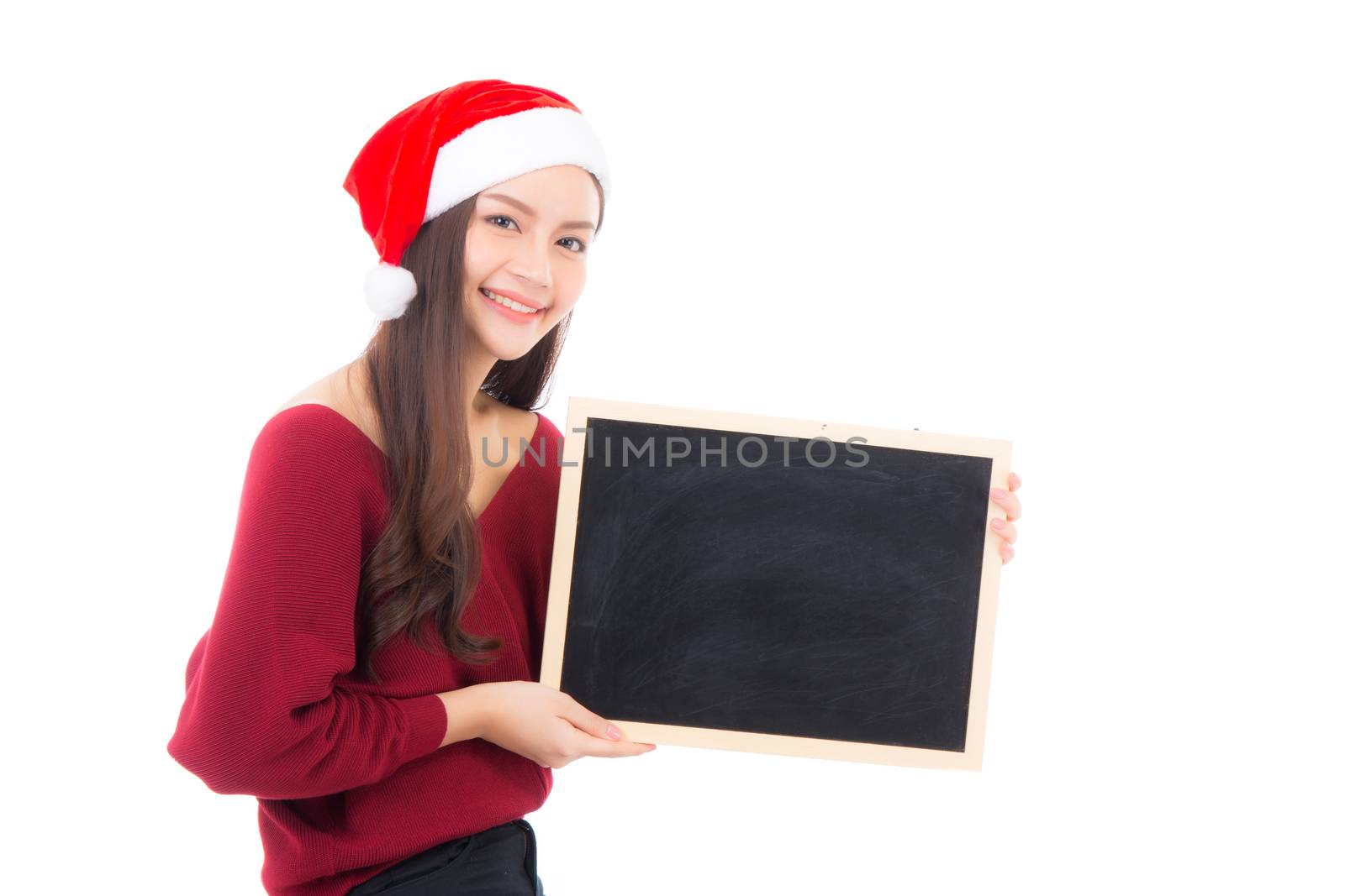 Portrait of beautiful christmas asian young woman in santa hat holding chalkboard with copyspace empty isolated on white background, xmas holiday concept.