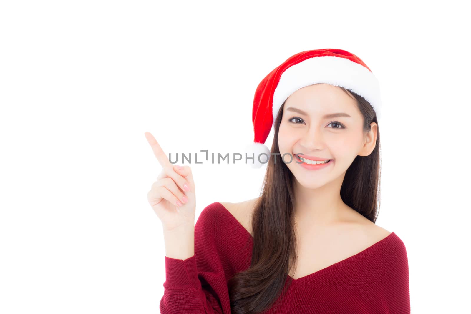Portrait of beautiful asian young woman pointing something in santa hat smile and happy, girl model isolated on white background, christmas and holiday concept.