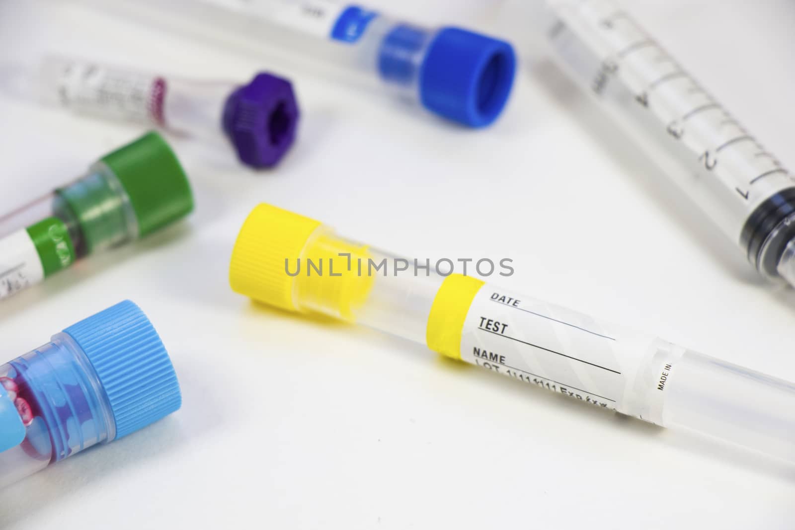 Blood test empty tubes samples on the white background, studio shoot. by Taidundua