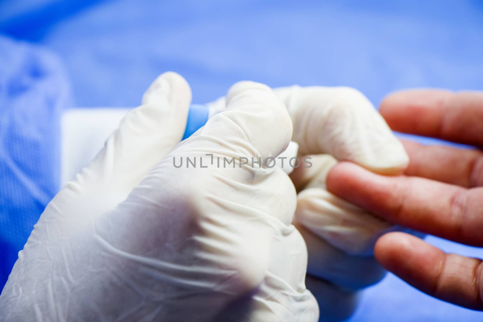 Insulin testing process, blood test and syringe. Injection in the hand. Patients and doctor. Studio shoot.