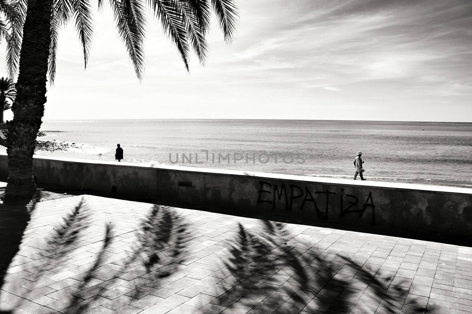 Mazarron, Murcia, Spain- October 3, 2019: Beautiful beach view from the promenade in a sunny and clear day in Mazarron, Murcia, Spain. Empathic word written on the wall.