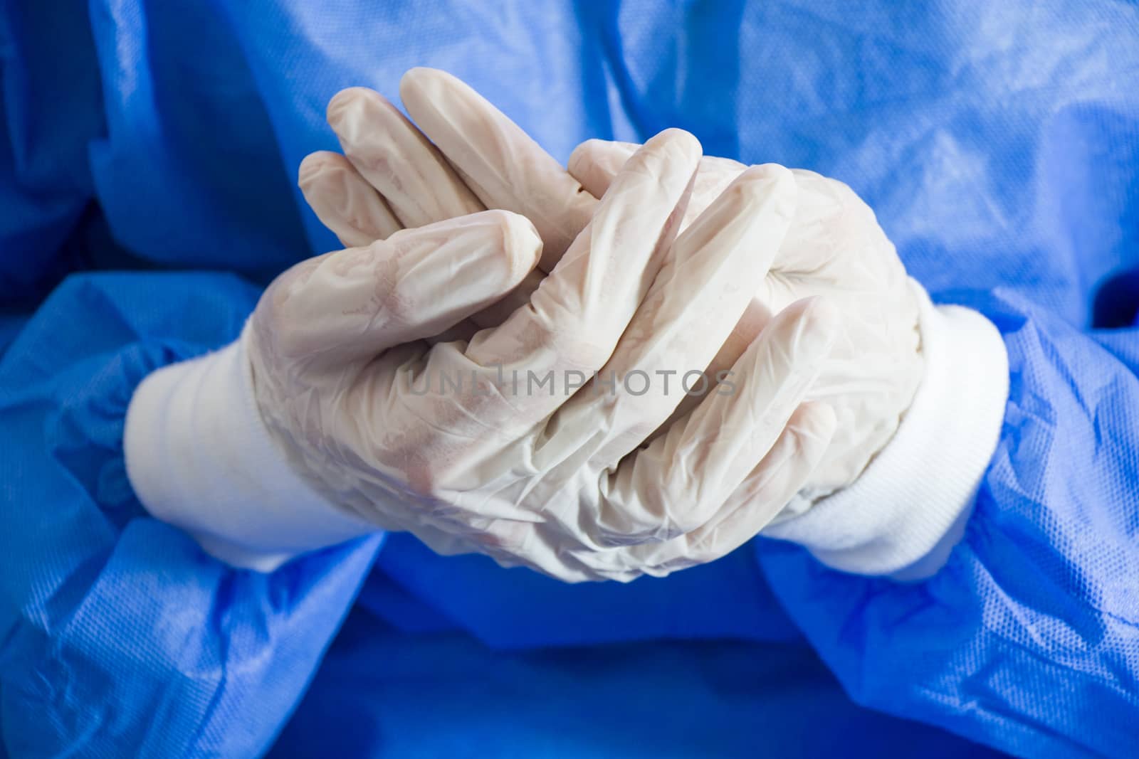 Doctors hands with sterile and disinfection white gloves close-up. Surgery and nurse uniform. by Taidundua