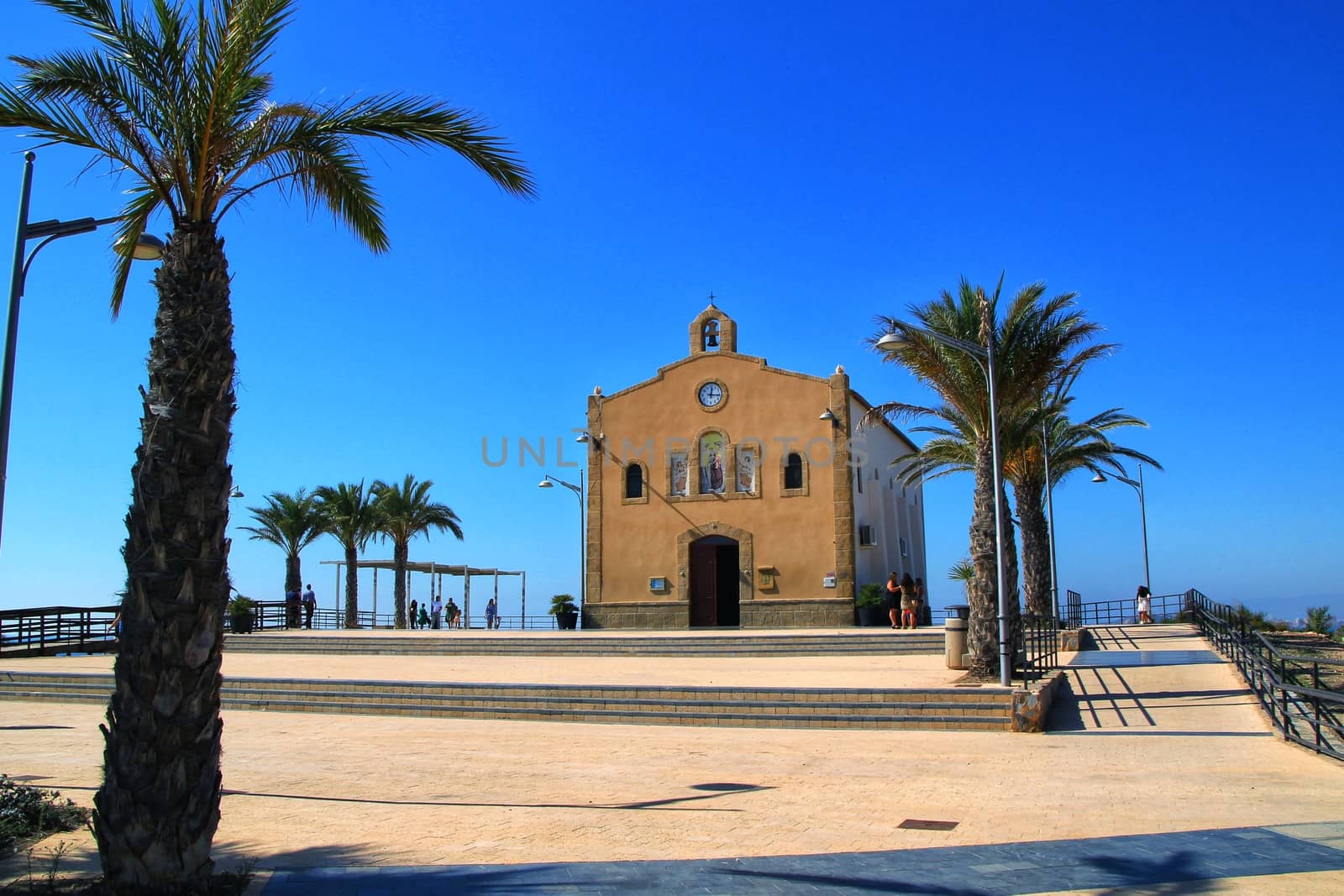 Isla Plana, Murcia, Spain- October 3, 2019: Old Virgen del Carmen hermitage built on the edge of a cliff in a cove in Isla Plana village, Cartagena, Spain