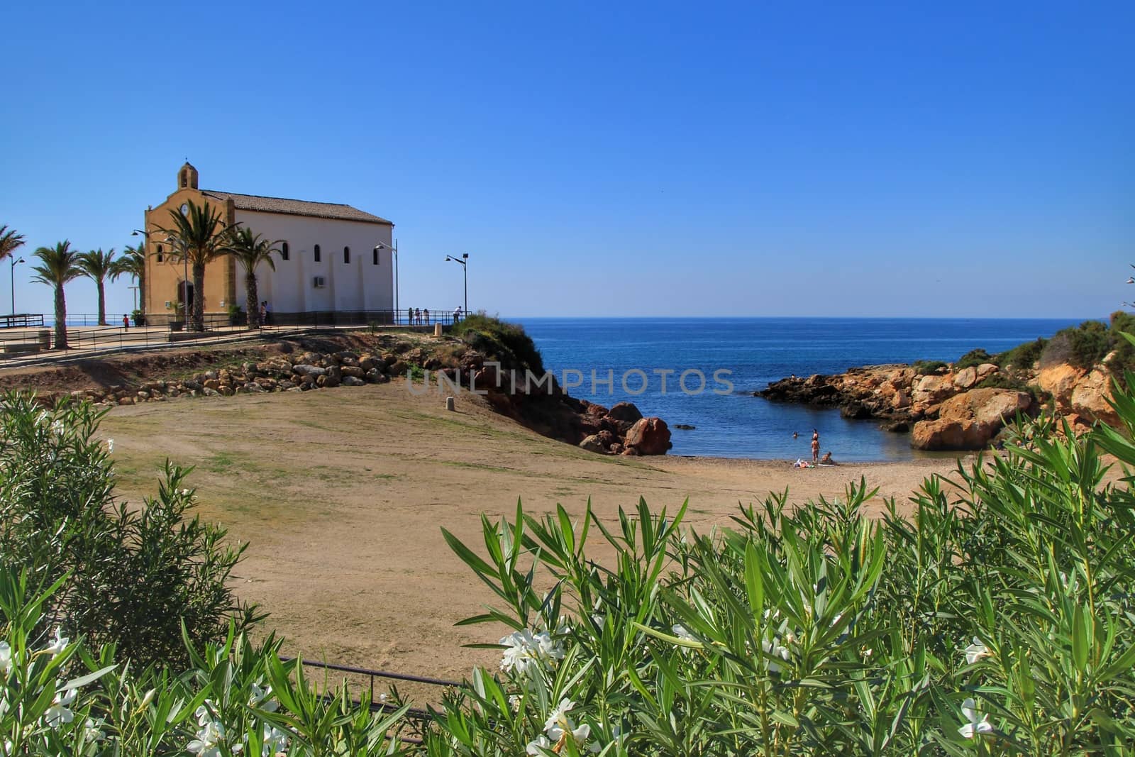 Isla Plana, Murcia, Spain- October 3, 2019: Old Virgen del Carmen hermitage built on the edge of a cliff in a cove in Isla Plana village, Cartagena, Spain