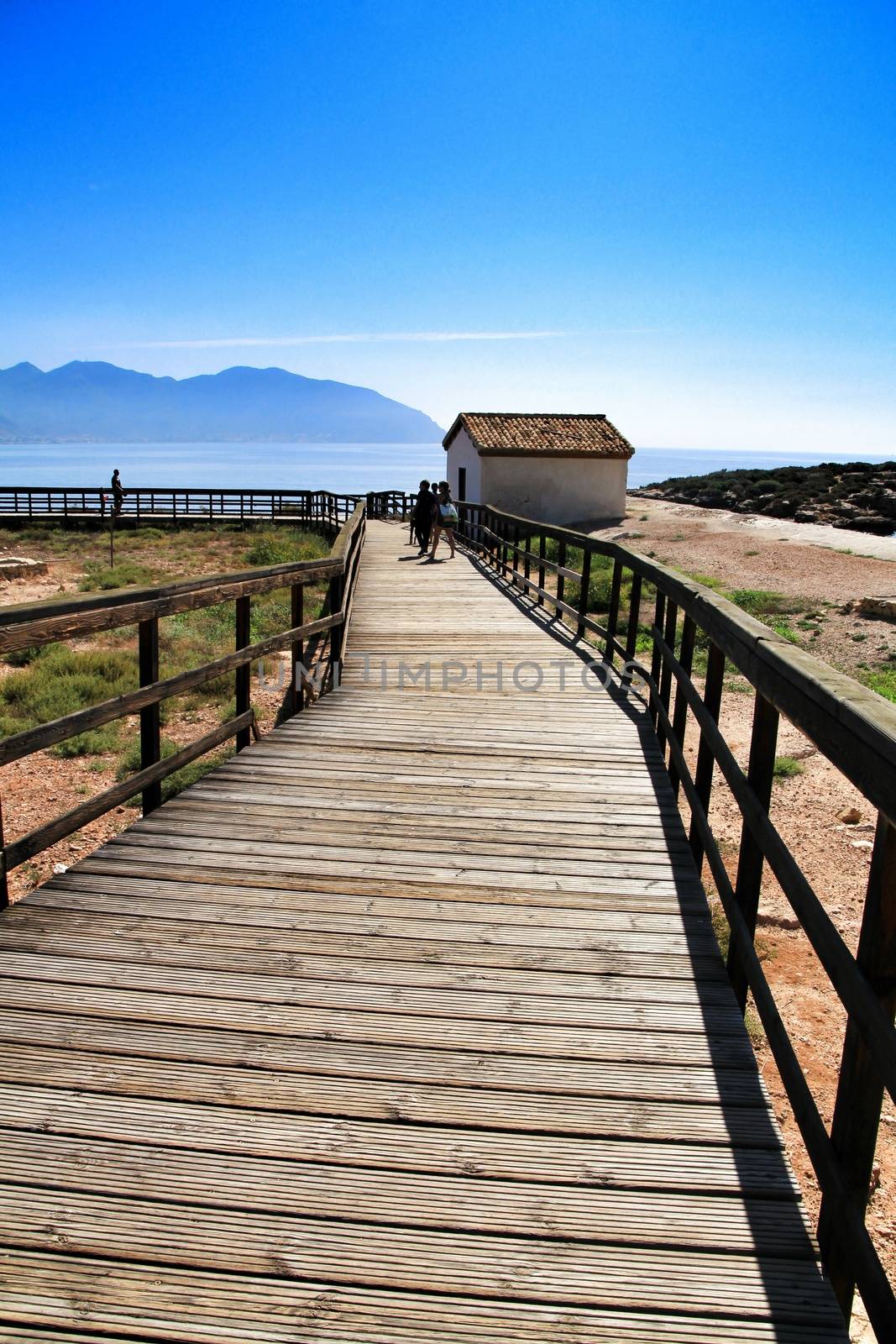 Isla Plana, Murcia, Spain-October 8, 2019:Wooden boardwalk along the beach in a sunny day in Isla Plana village in Cartagena, Murcia, Spain