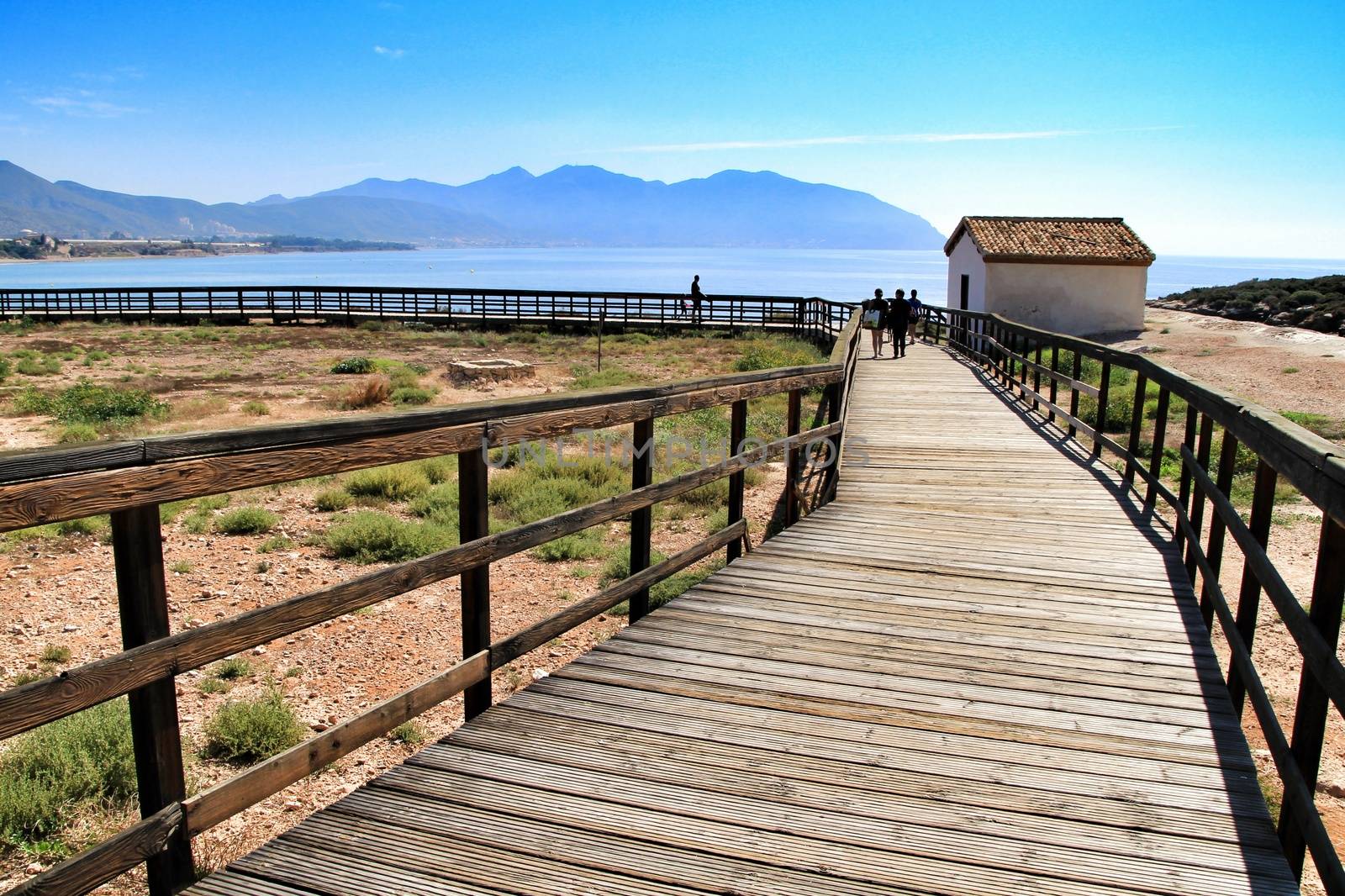 Isla Plana, Murcia, Spain-October 8, 2019:Wooden boardwalk along the beach in a sunny day in Isla Plana village in Cartagena, Murcia, Spain