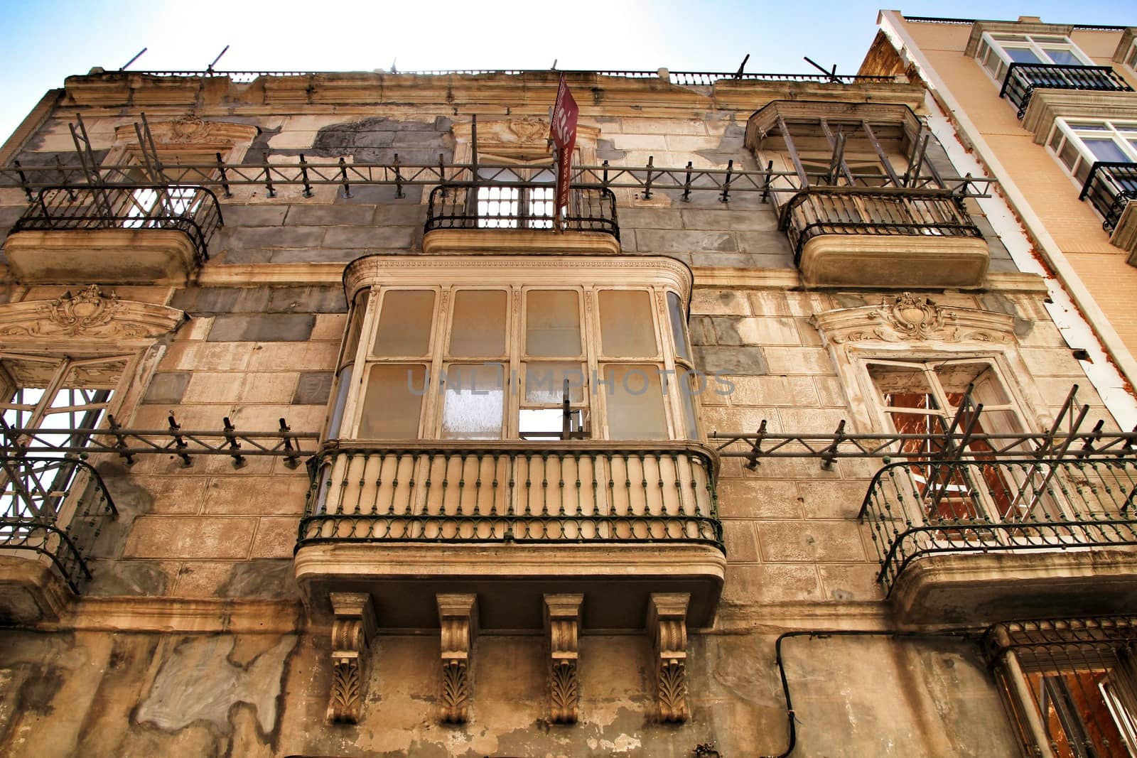 Cartagena, Murcia, Spain- July 27, 2019: Old colorful and beautiful facade in works in Cartagena city in Summer.