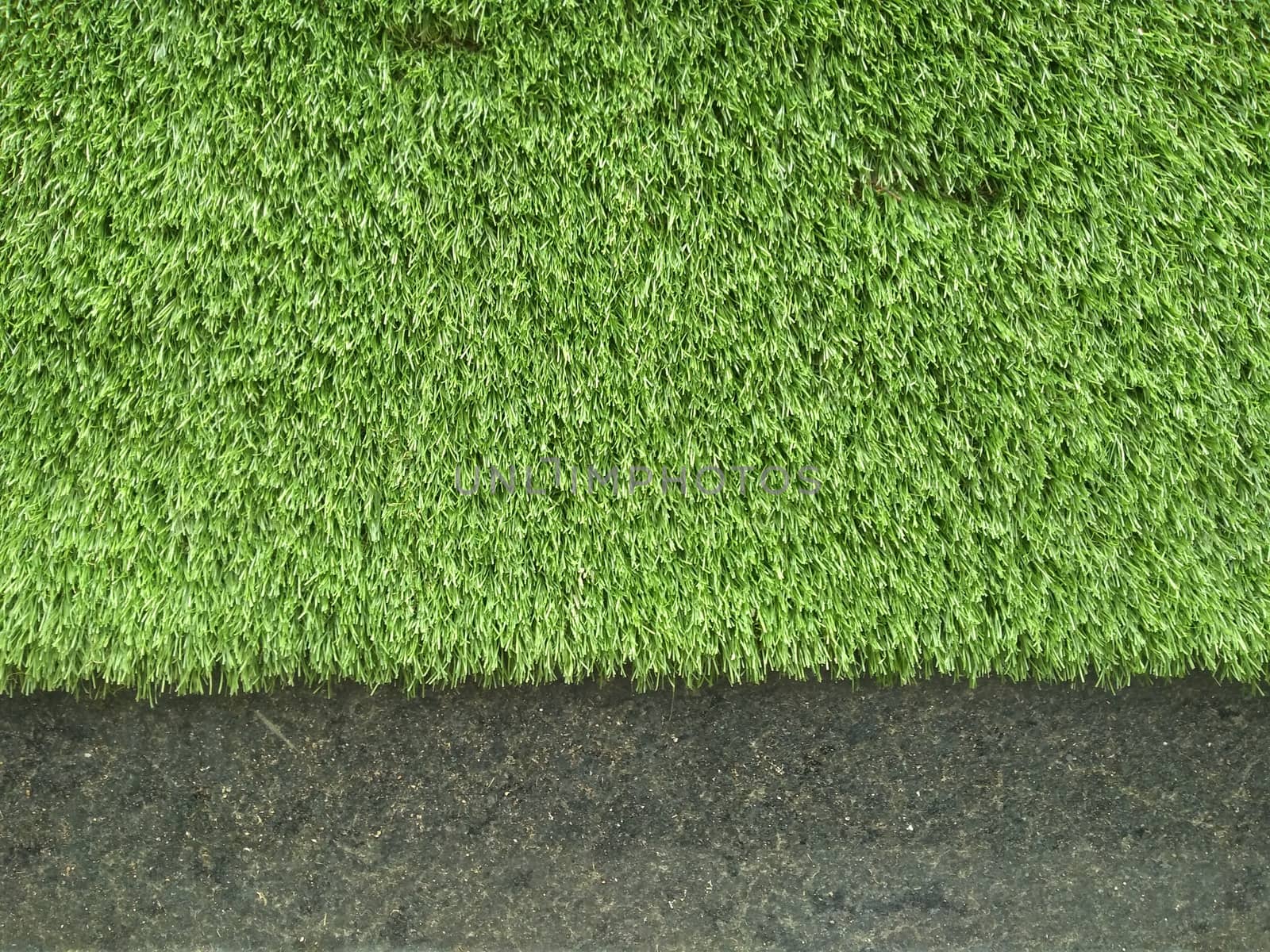 Artificial greener grass backdrop close up photo.