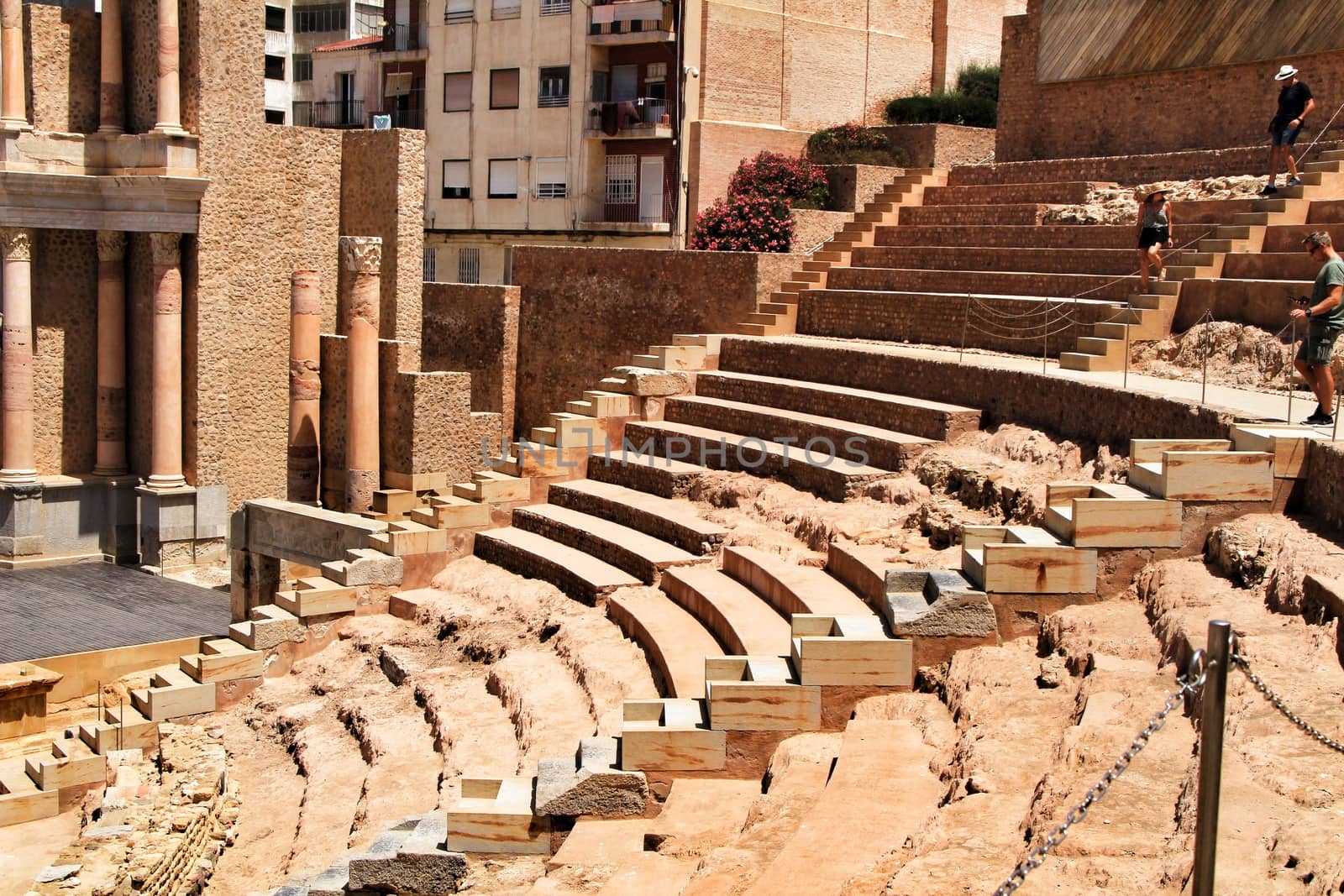 Cartagena, Murcia, Spain- July 25, 2019: Tourists visiting Archeological remains of the roman amphitheater of Cartagena in a sunny day of summer.