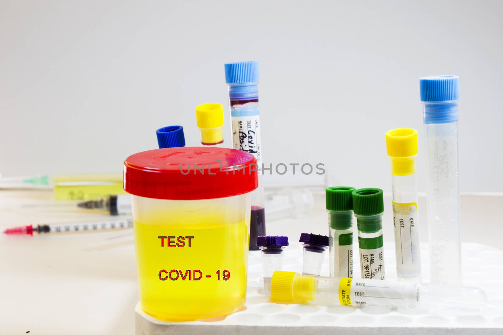 Covid-19 and coronavirus test, medical urine and pee test with blood and other tubes on the white background, colorful lab test containers, research and analysis of NCOV viruses, laboratory tests studio shoot