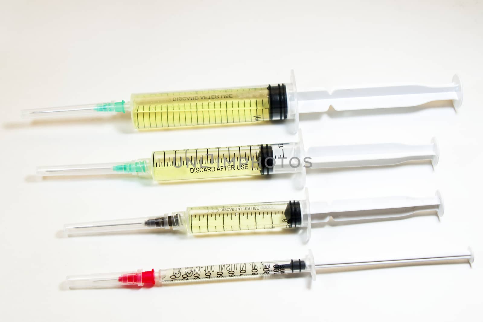 Medical needle on the sterile table with liquid vaccine, yellow vaccine for viruses. Vaccination and antibiotics. by Taidundua