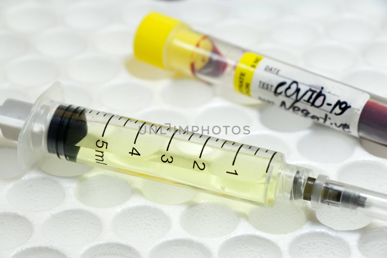 Medical needle and blood tube, corona virus or covid-19 vaccine. by Taidundua