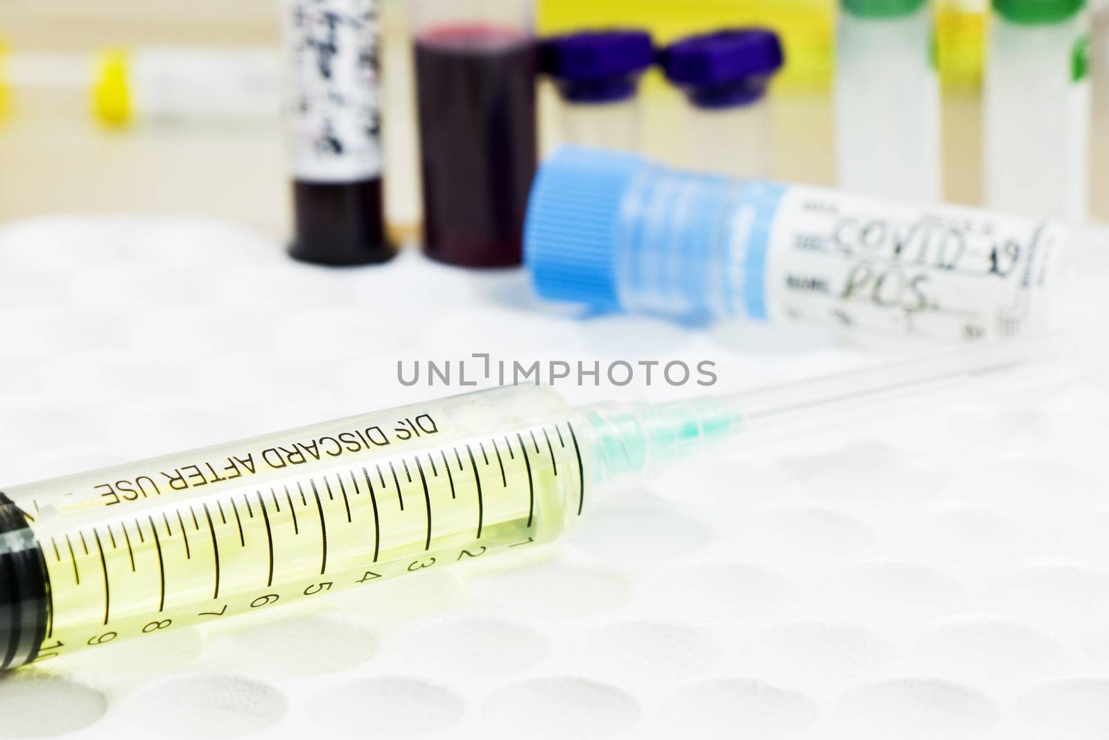 Medical needle and blood tube, corona virus or covid-19 vaccine. by Taidundua