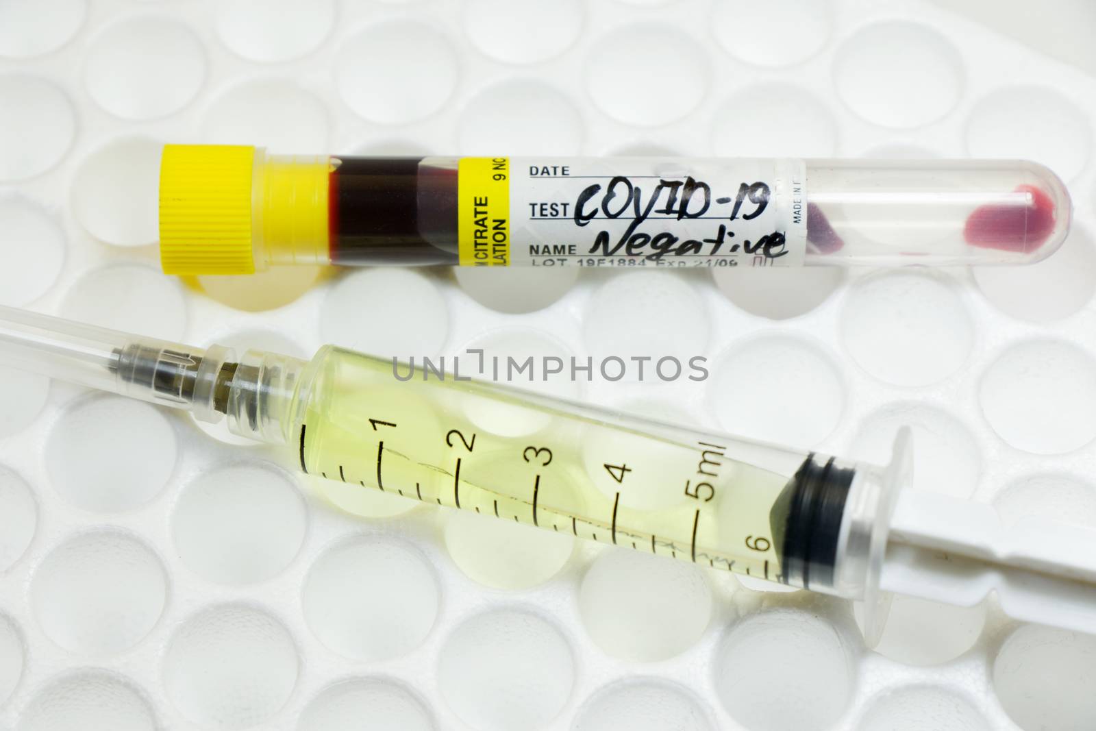 Medical needle and blood tube, corona virus or covid-19 vaccine. by Taidundua