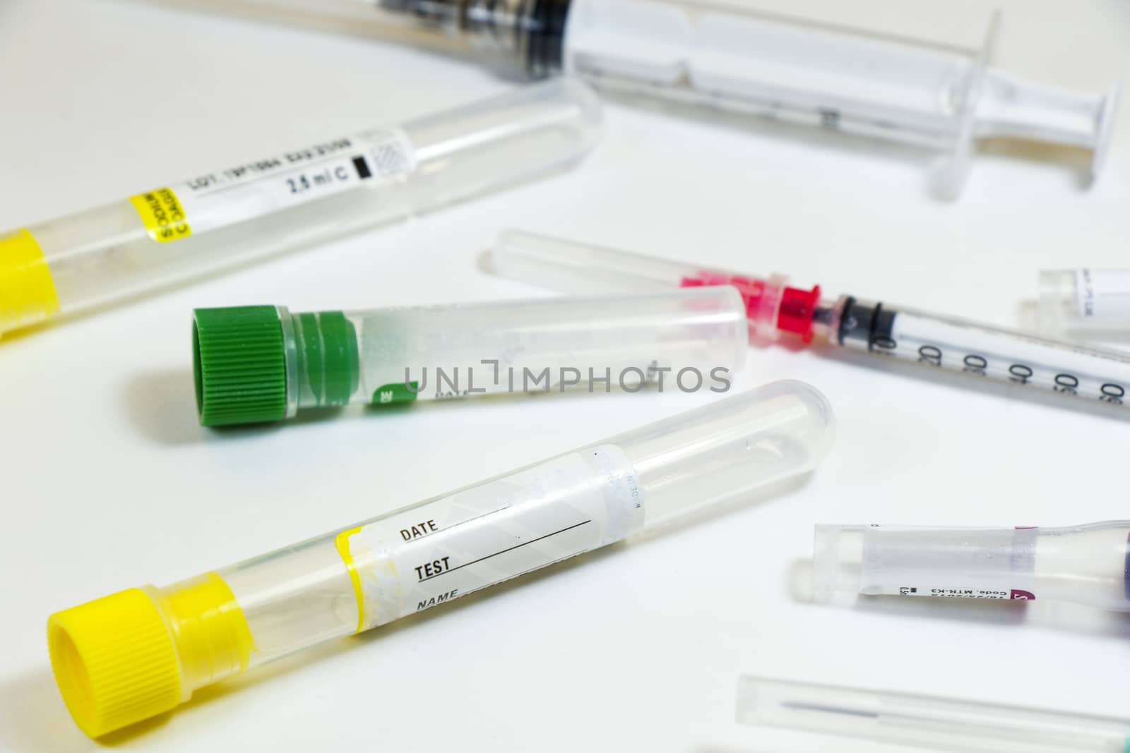 Blood test empty tubes samples on the white background, studio shoot. Colorful tubes, name, date and test.