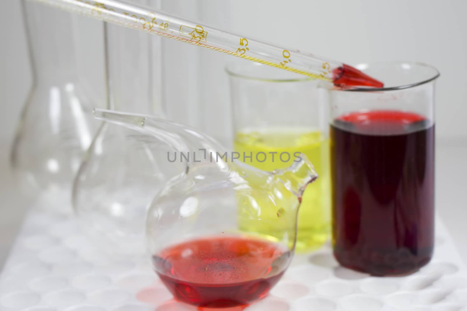 Laboratory chemical liquid elements and research diagnoses, instruments and objects in the sterile table, glassware and pipette. Studio shoot.