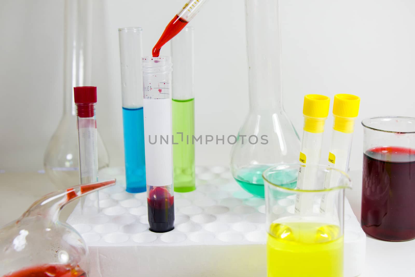 Laboratory chemical liquid elements and research diagnoses, instruments and objects in the sterile table, glassware and pipette. by Taidundua