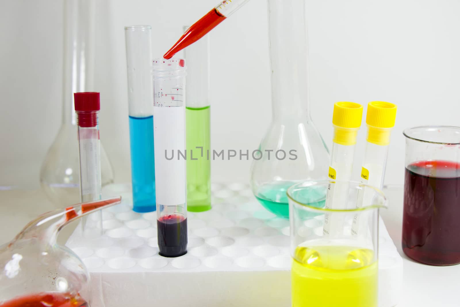 Laboratory chemical liquid elements and research diagnoses, instruments and objects in the sterile table, glassware and pipette. by Taidundua