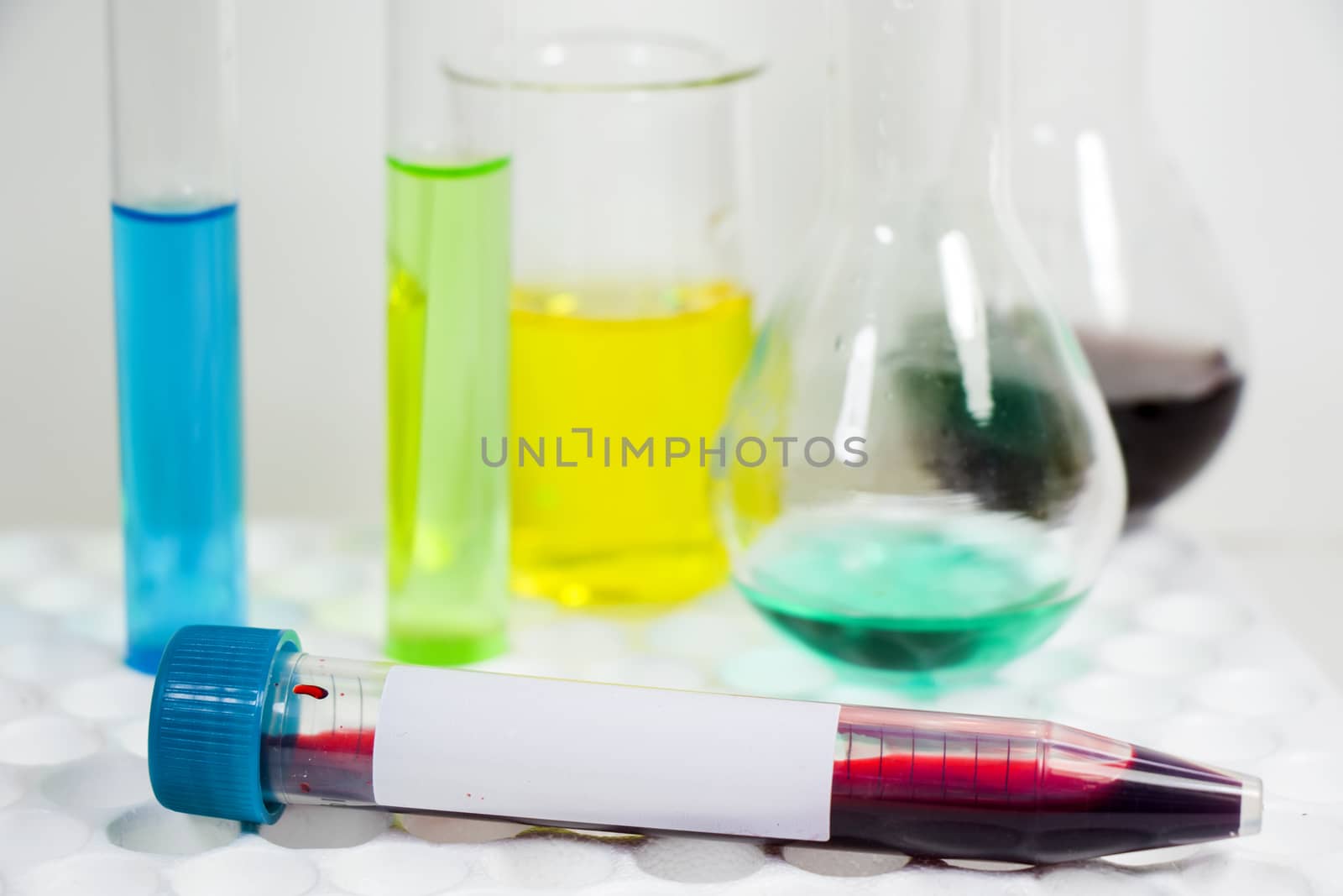 Blood test tube sample without name, empty space for text, laboratory background by Taidundua