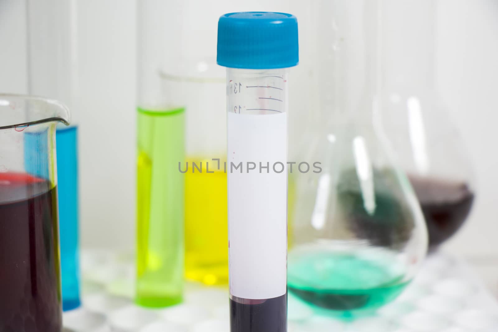 Blood test tube sample without name, empty space for text, laboratory background by Taidundua