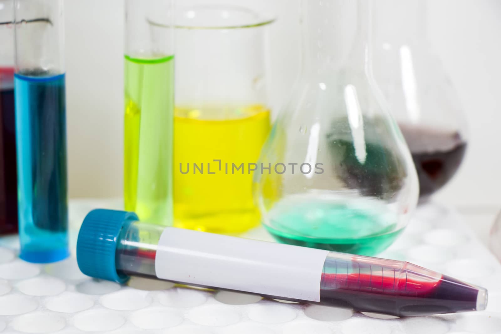 Blood test tube sample without name, empty space for text, laboratory background, copy paste.