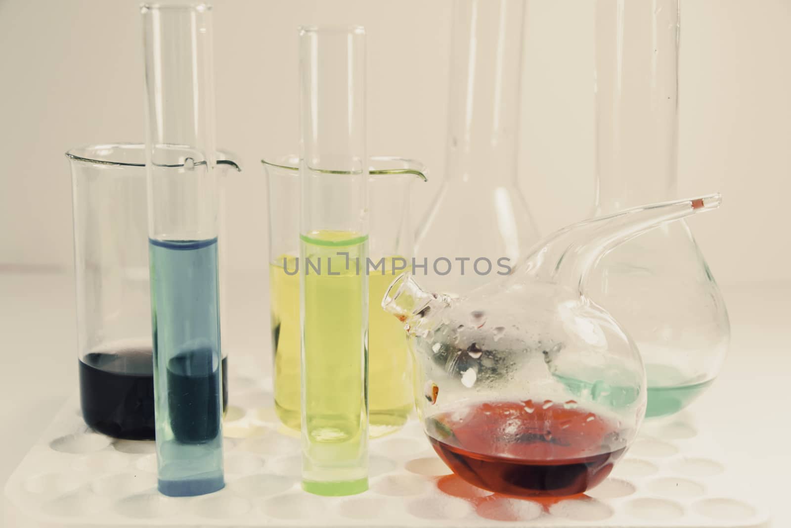 Laboratory chemical liquid elements and research diagnoses, instruments and objects in the sterile table, glassware by Taidundua