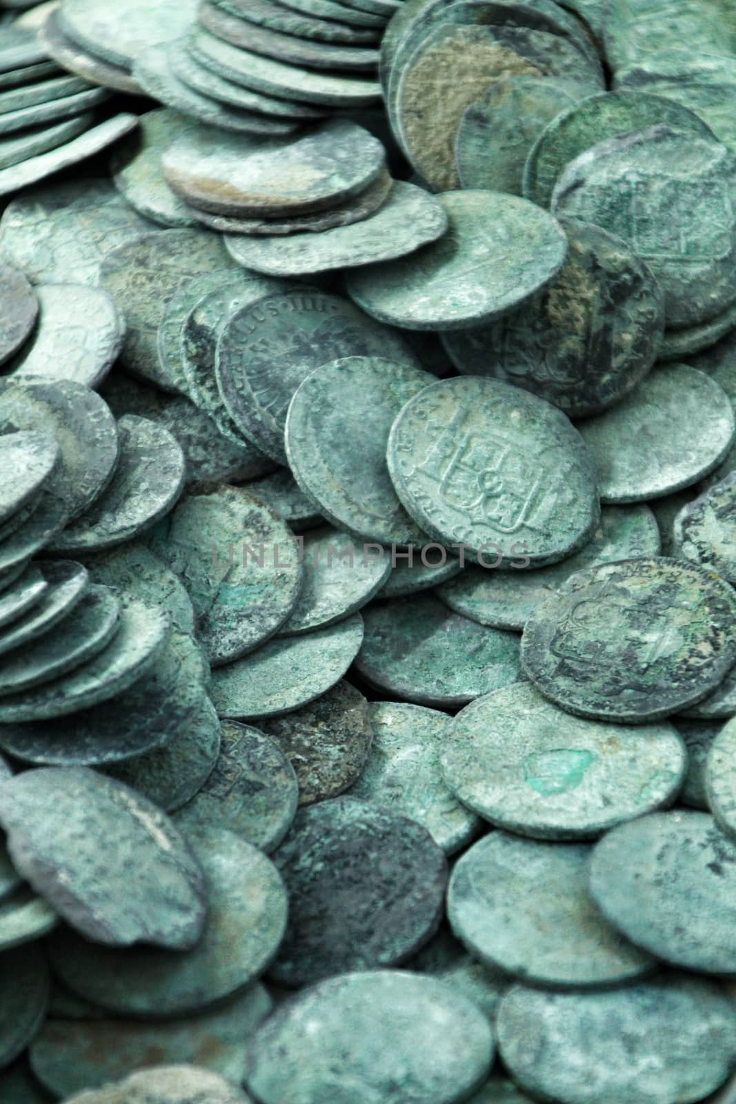 Cartagena, Murcia, Spain- July 25, 2019: Spanish silver coins recovered from the ocean floor by the Odissey company and exposed in underwater museum in Cartagena, Spain
