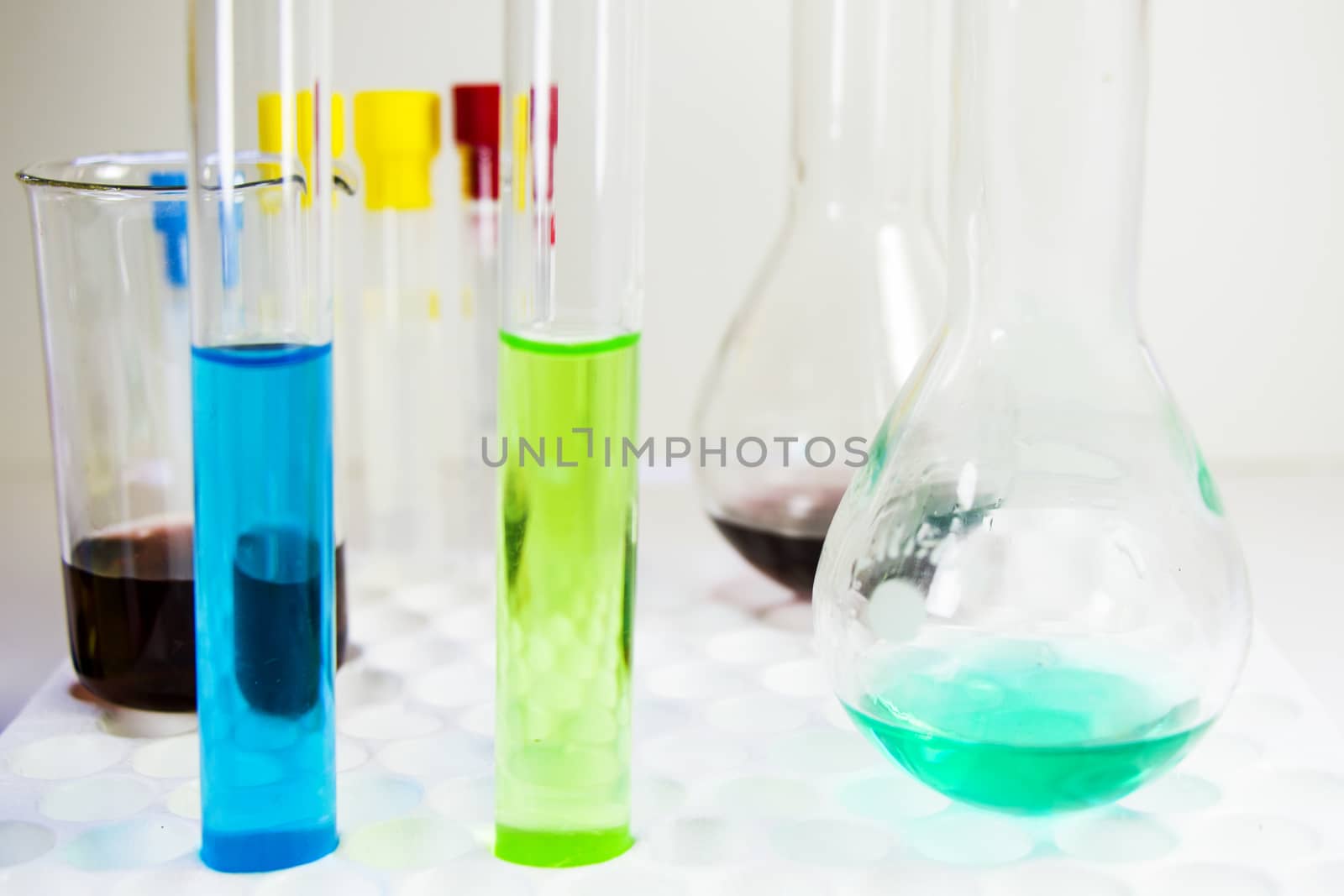 Laboratory chemical liquid elements and research diagnoses, instruments and objects in the sterile table, glassware and pipette.