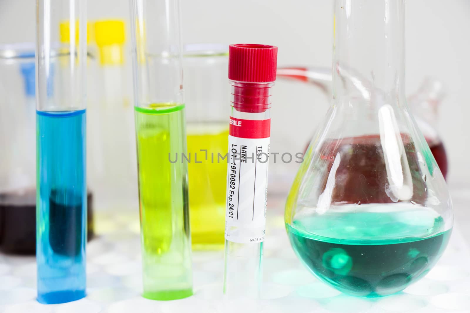 Blood test tube sample without name, empty space for text, laboratory background, copy paste.