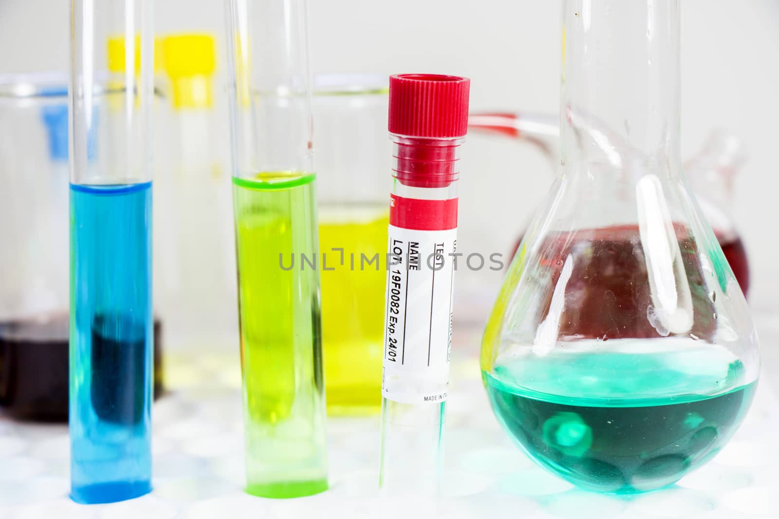 Blood test tube sample without name, empty space for text, laboratory background, copy paste.