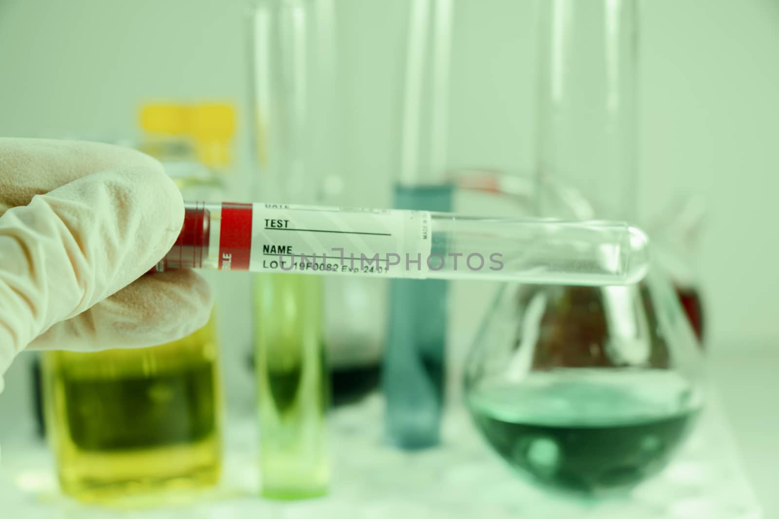 Blood test tube sample without name, empty space for text, laboratory background, copy paste.