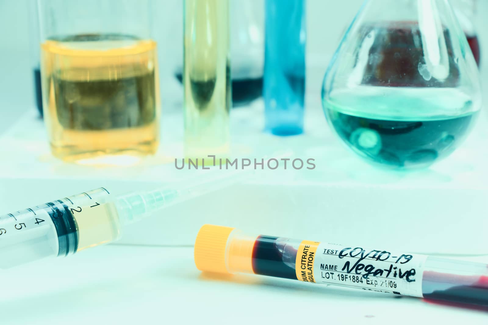 Covid - 19, coronavirus, covid blood test tube sample and needle with vaccine, laboratory diagnosis.