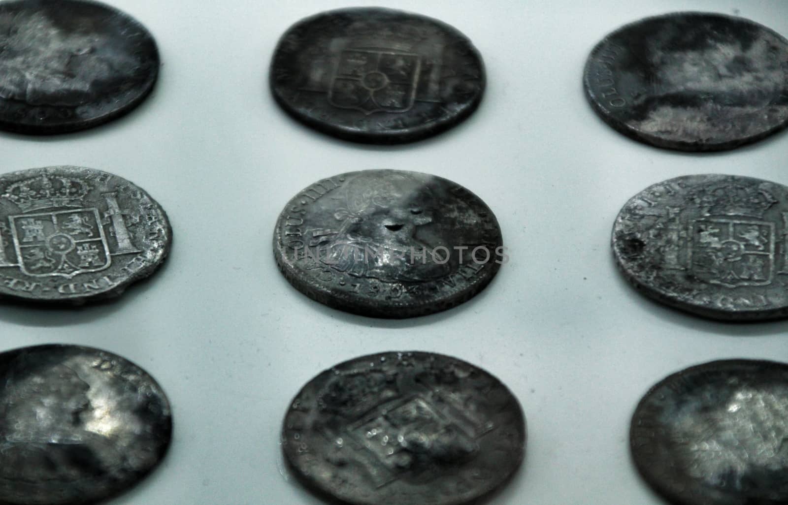 Cartagena, Murcia, Spain- July 25, 2019: Spanish silver coins recovered from the ocean floor by the Odissey company and exposed in underwater museum in Cartagena, Spain