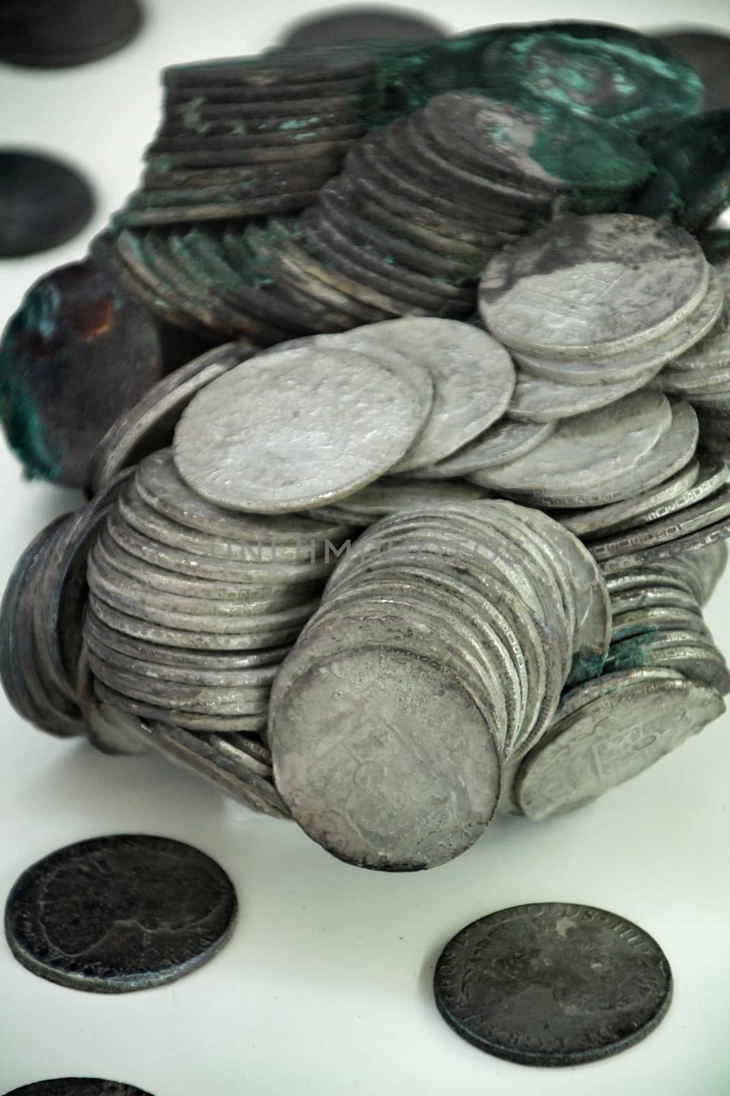 Cartagena, Murcia, Spain- July 25, 2019: Spanish silver coins recovered from the ocean floor by the Odissey company and exposed in underwater museum in Cartagena, Spain