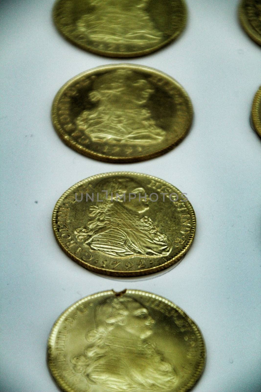 Cartagena, Murcia, Spain- July 25, 2019: Spanish gold coins recovered from the ocean floor by the Odissey company and exposed in underwater museum in Cartagena, Spain