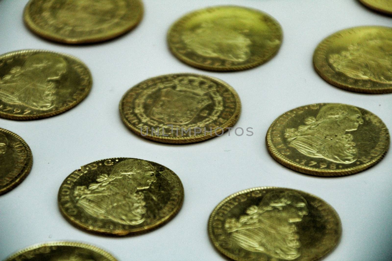Cartagena, Murcia, Spain- July 25, 2019: Spanish gold coins recovered from the ocean floor by the Odissey company and exposed in underwater museum in Cartagena, Spain