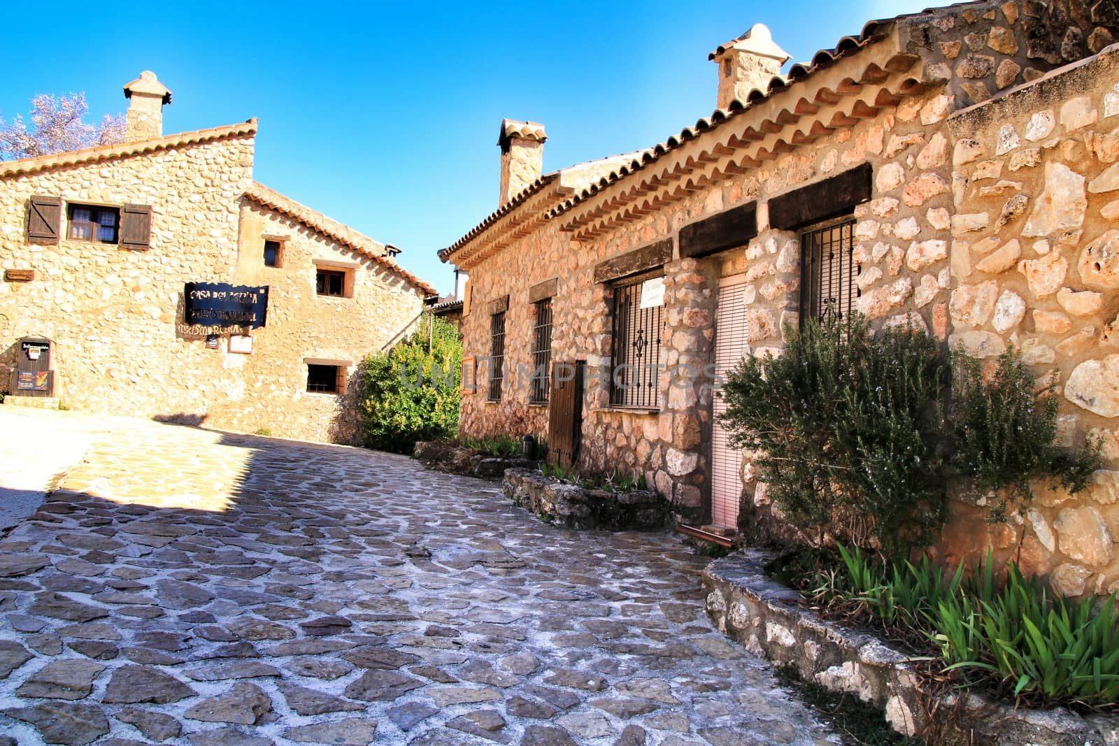 Riopar Viejo, Albacete, Spain- February 8, 2019: Tourists visiting and walking through cobbled stone streets in Riopar Viejo village, Castilla La Mancha, Spain. Sunny day of winter.