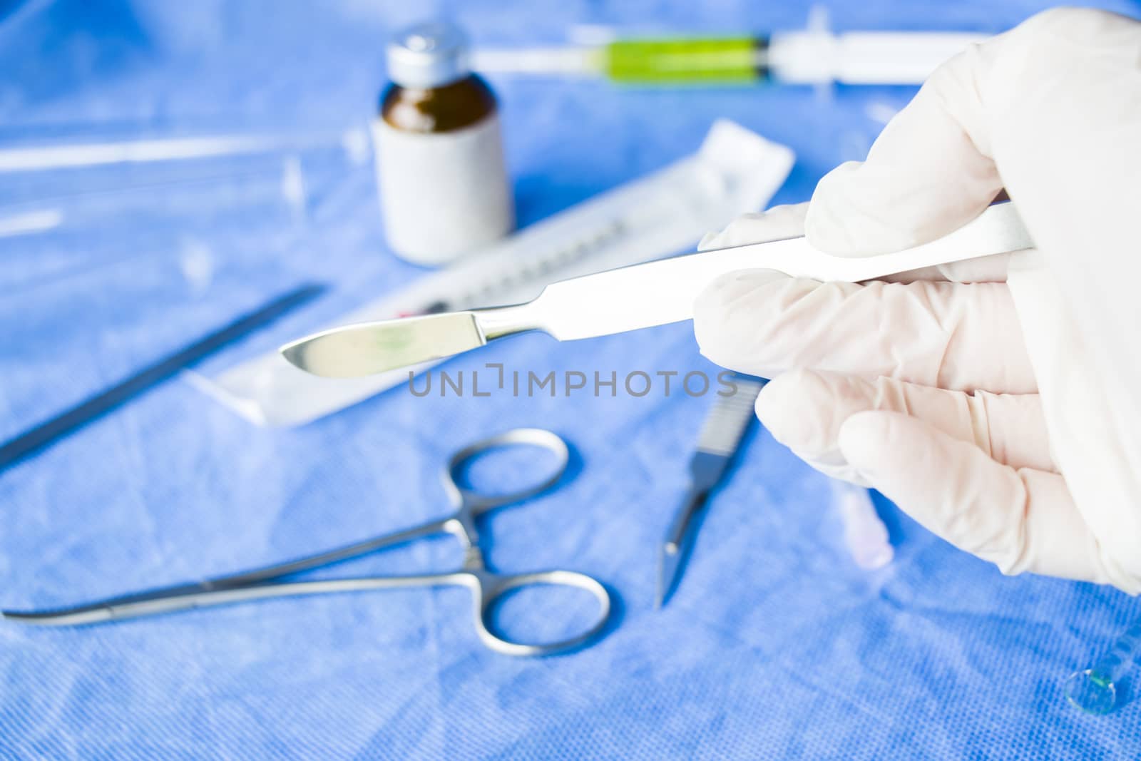 Surgery knife holding on the white background, studio shot. Operation equipment. Surgery procedure. by Taidundua