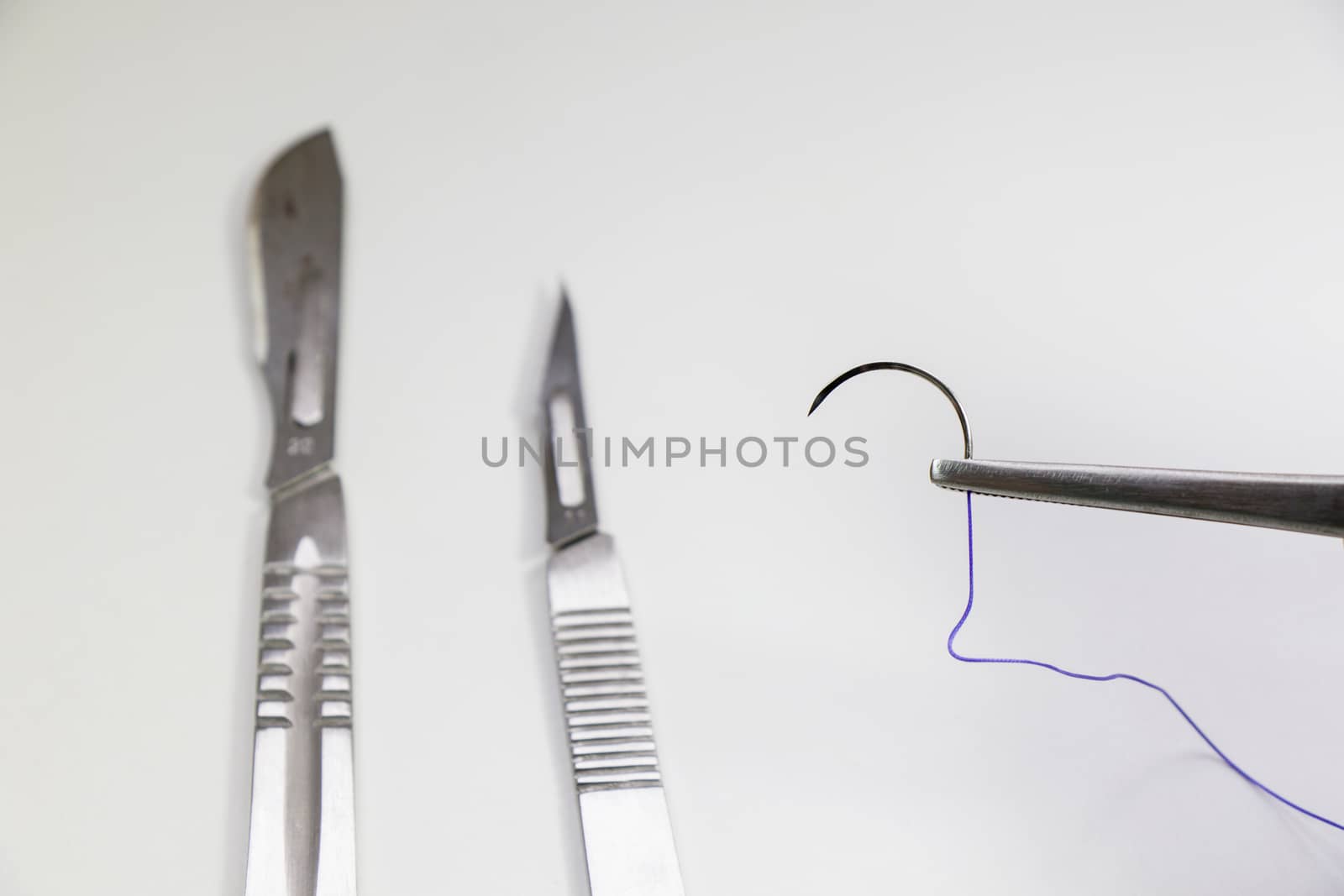 Dissection Kit - Absorbable suture, polyglycolic acid. Surgery operation equipment, knife, needle and suture. Studio shoot.