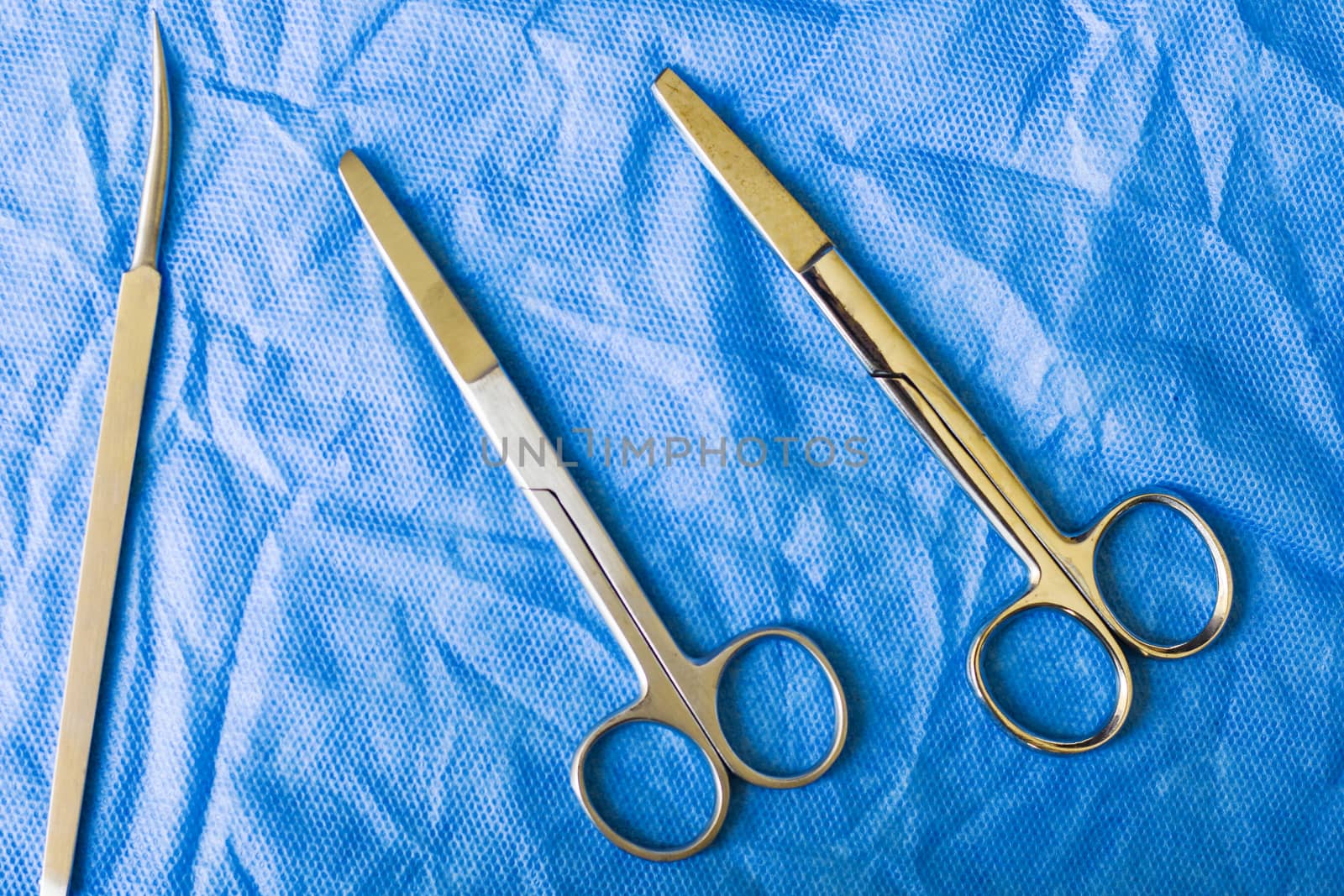 Surgical scissors on the blue sterile table by Taidundua