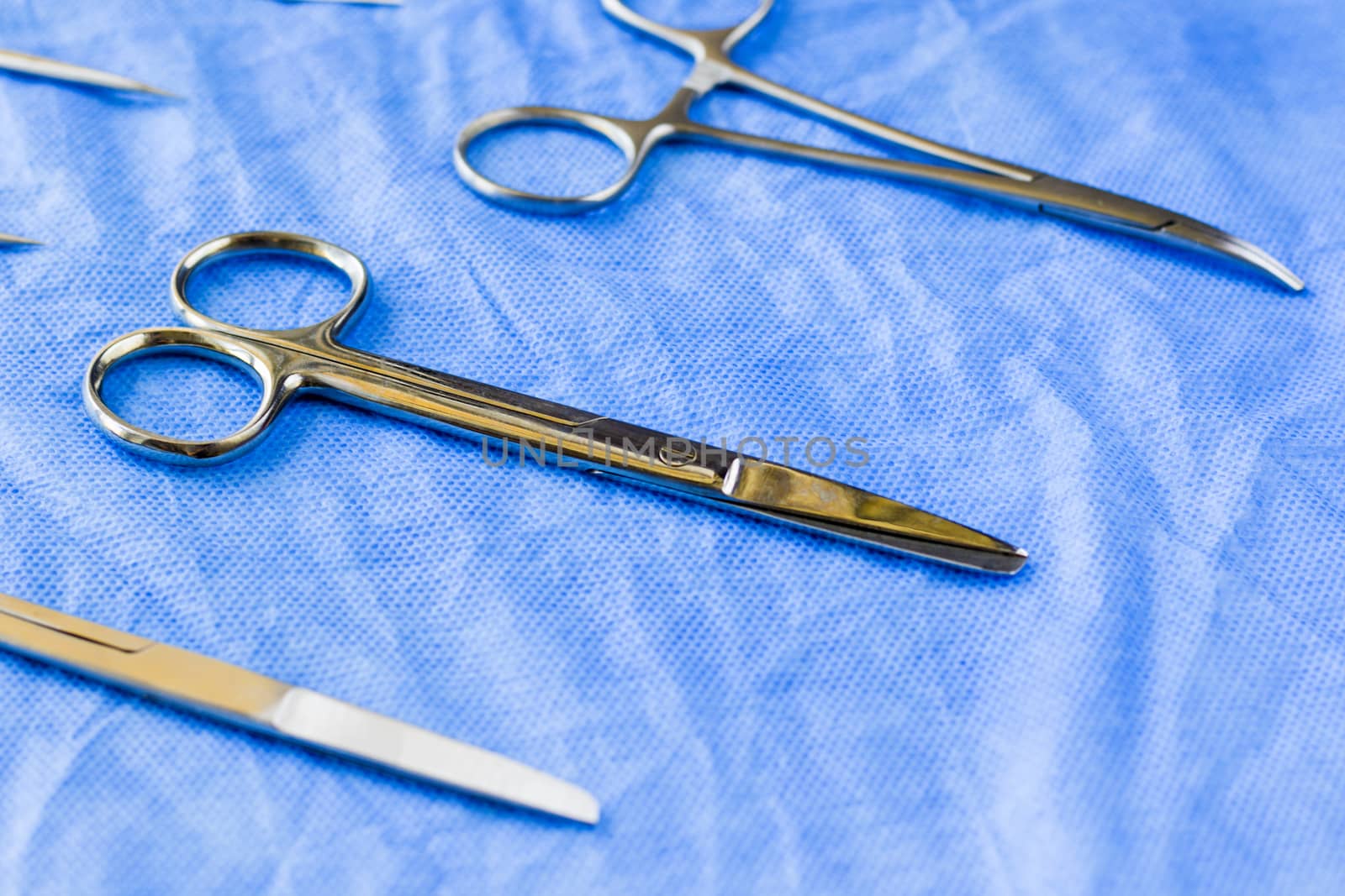 Surgical scissors on the blue sterile table, operation table