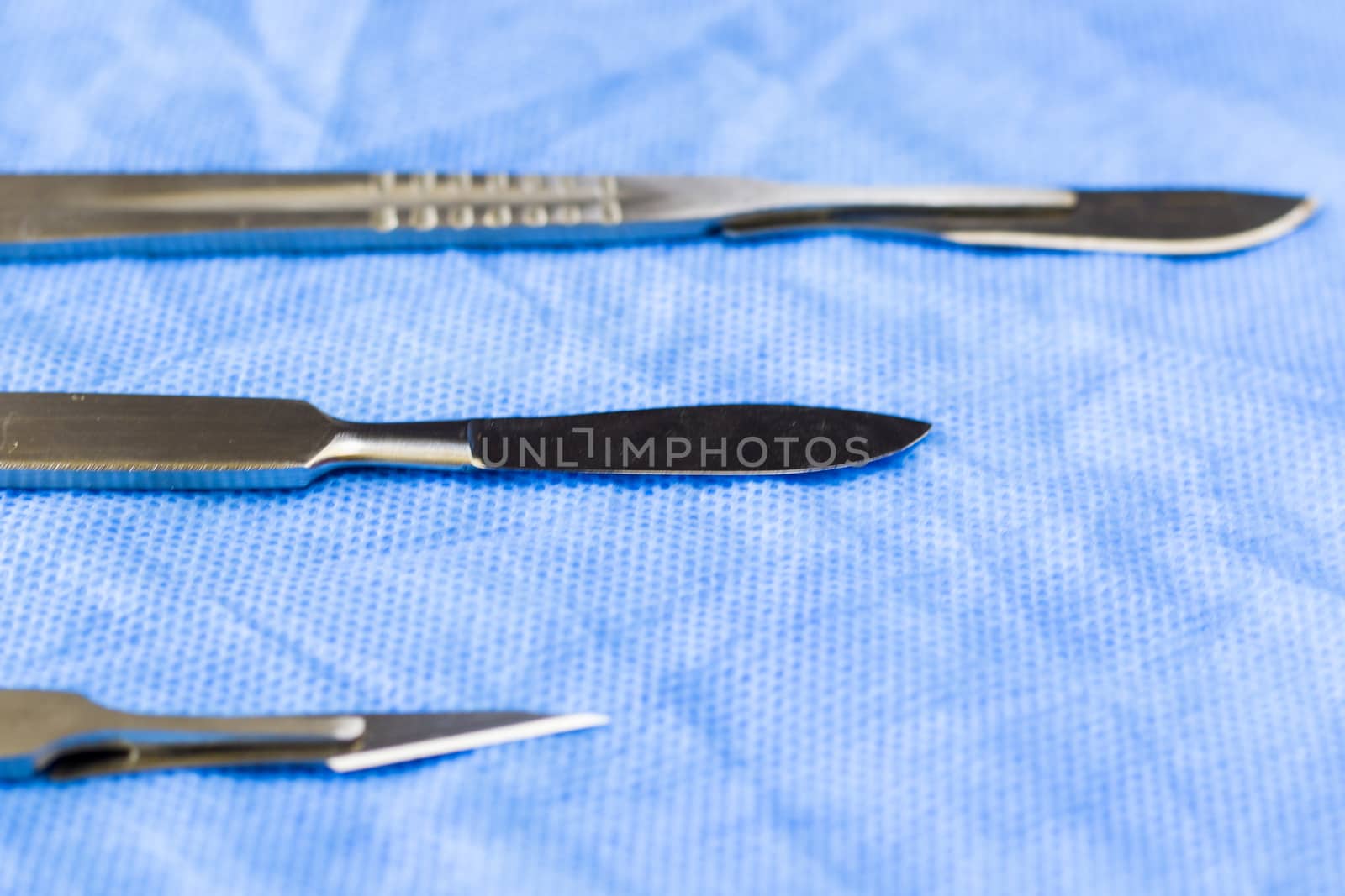 Surgery blade on the sterile table, scalpel close-up