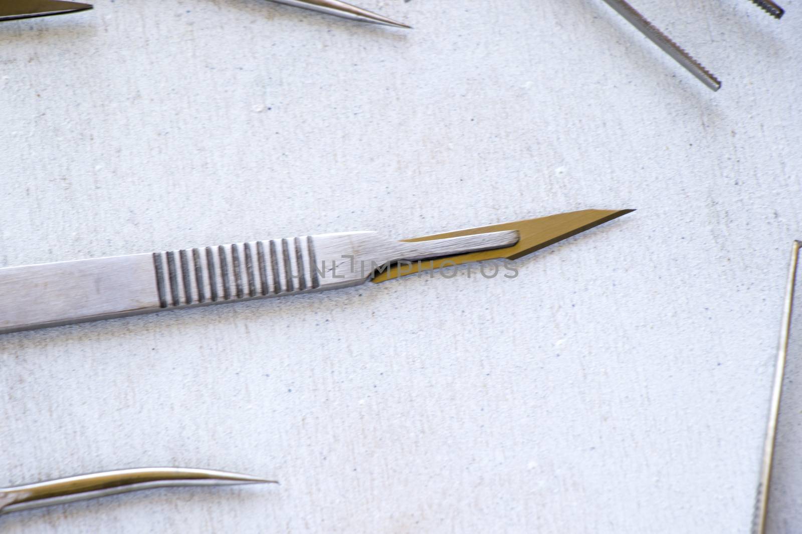 Surgery blade on the sterile table, scalpel close-up