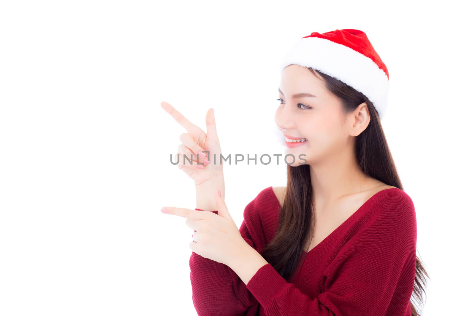 Portrait of beautiful asian young woman pointing something in santa hat smile and happy, girl model isolated on white background, christmas and holiday concept.