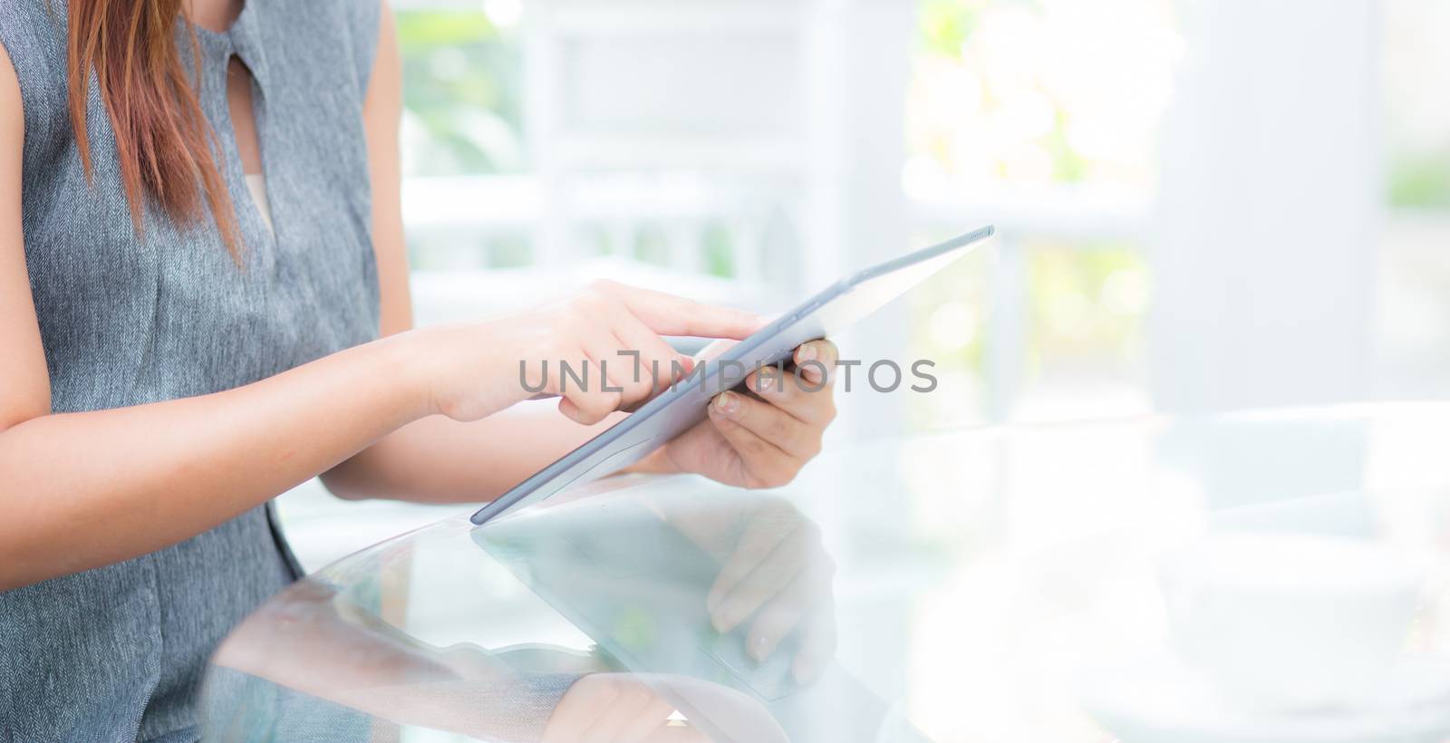 Closeup view of woman holding digital tablet on touch screen device working internet online or open email at office, communication and social networking concept.